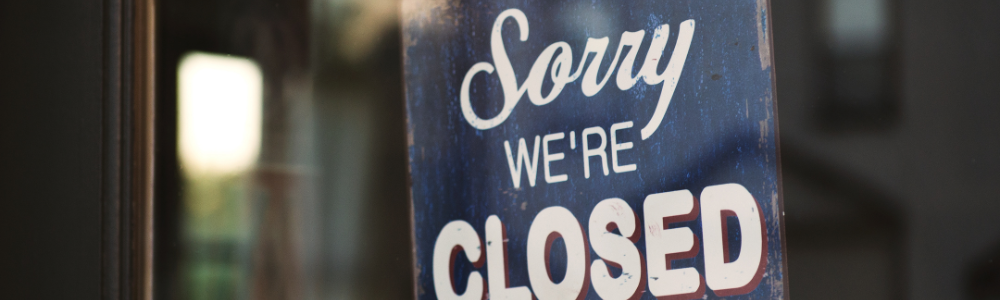 blue and white sorry we're closed wooden signage