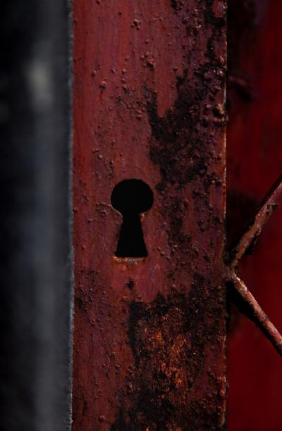 Photo of keyhole on red door