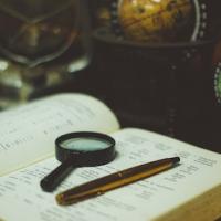 Open book and magnifying glass